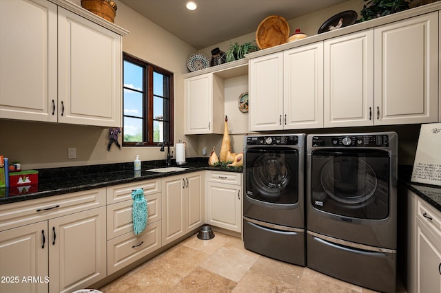 laundry area featuring cabinet space, washer and clothes dryer, light stone finish floors, and recessed lighting