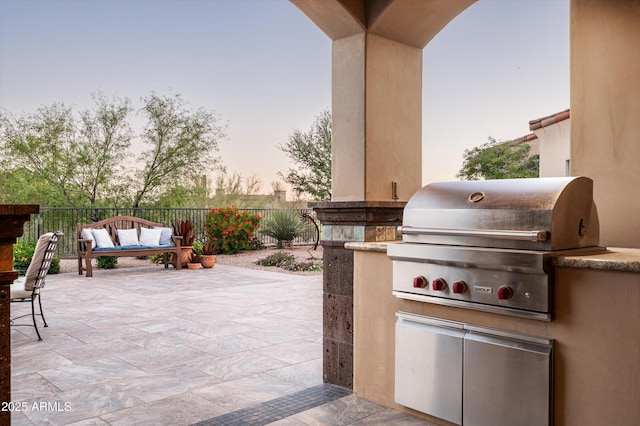 view of patio / terrace featuring exterior kitchen, area for grilling, fence, and an outdoor living space