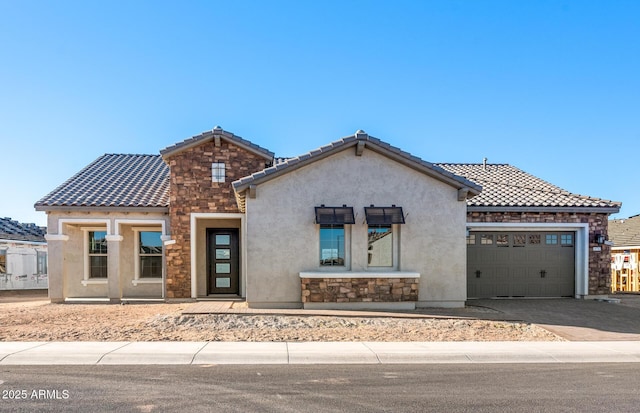 view of front of property with stone siding, a tile roof, an attached garage, and stucco siding