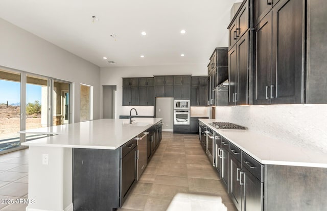 kitchen featuring light tile patterned floors, stainless steel appliances, recessed lighting, light countertops, and backsplash