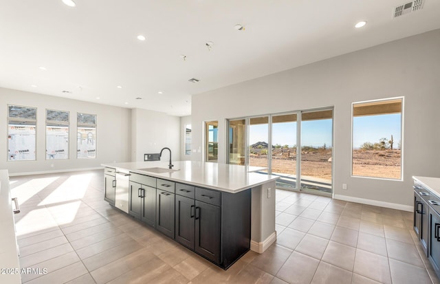 kitchen featuring light countertops, visible vents, a sink, and stainless steel dishwasher