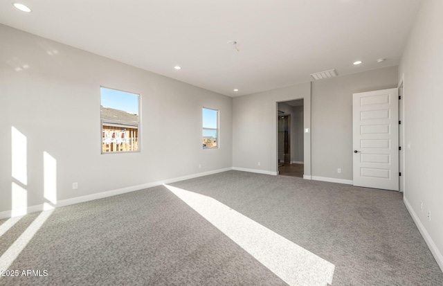 unfurnished room featuring recessed lighting, carpet, visible vents, and baseboards