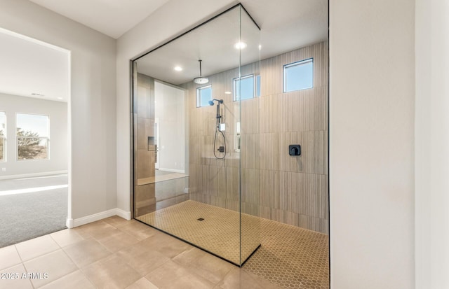 full bathroom featuring tile patterned floors, walk in shower, and baseboards