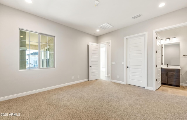 unfurnished bedroom featuring light carpet, recessed lighting, visible vents, and baseboards