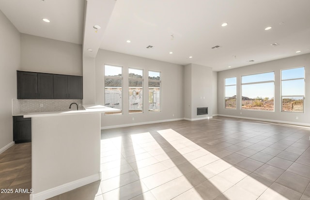 unfurnished living room with recessed lighting, visible vents, baseboards, and light tile patterned flooring