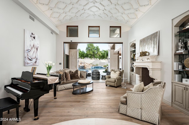 living room featuring vaulted ceiling and light wood-type flooring