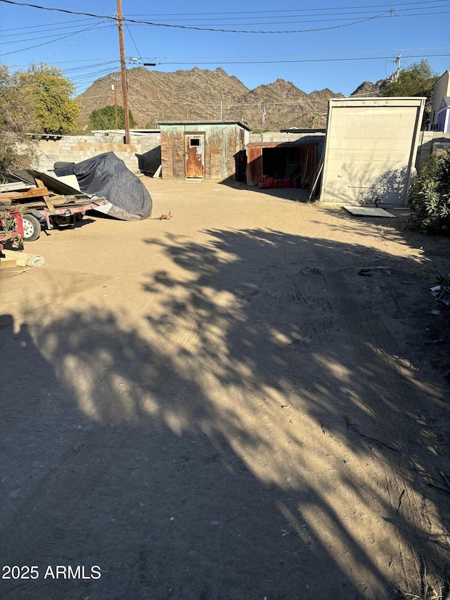 exterior space featuring a mountain view and a storage shed