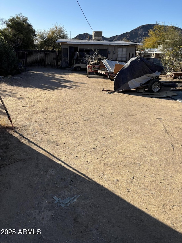 view of yard featuring a mountain view, central AC, and a carport