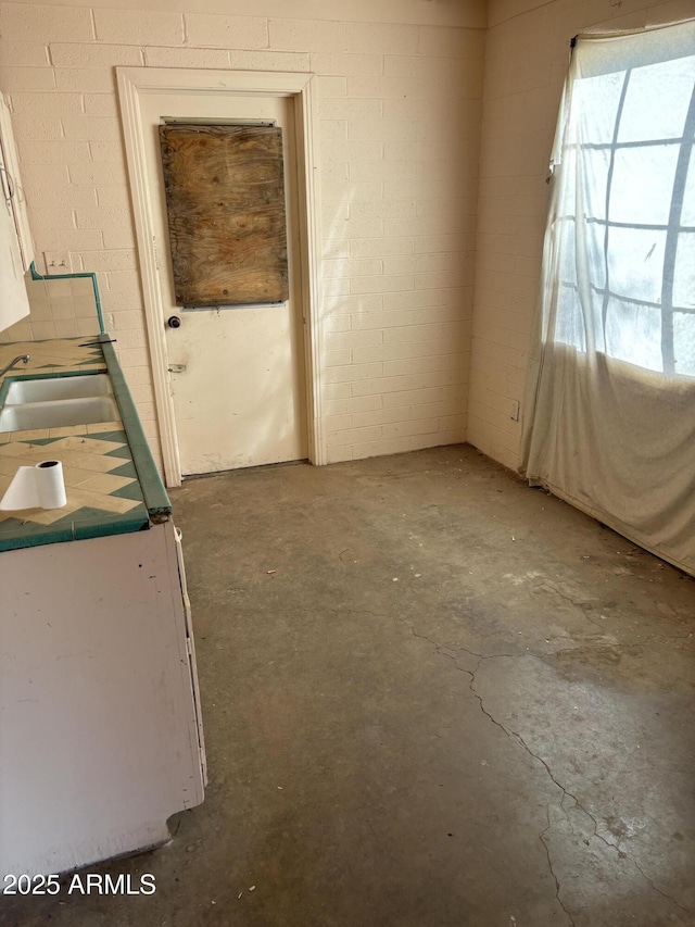 spare room with sink and concrete floors