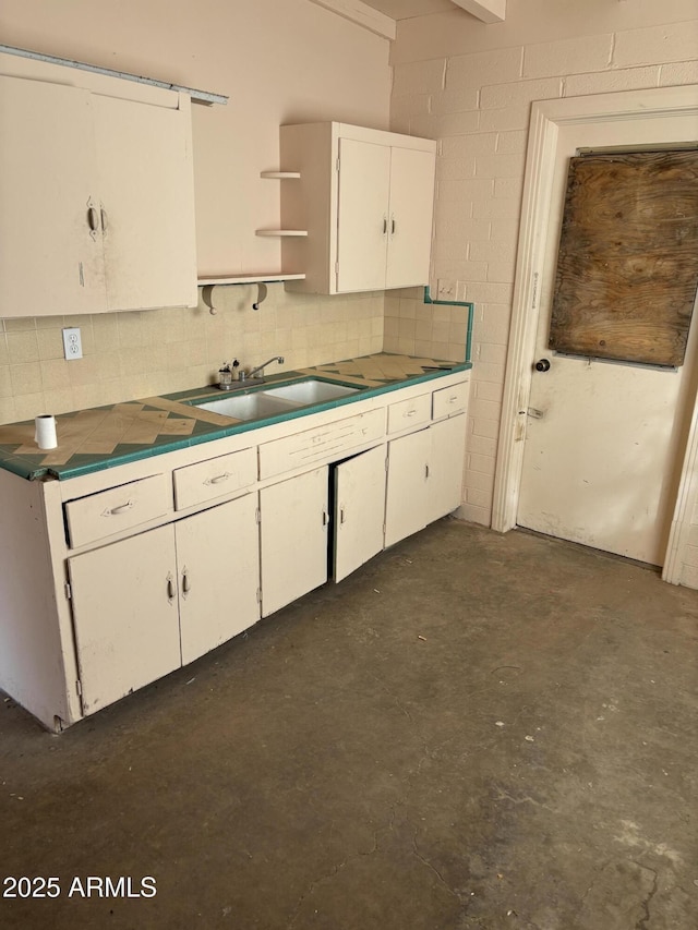 kitchen with white cabinetry and sink