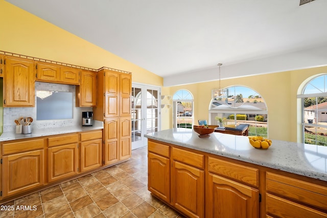 4701 N Sheridan Ln, Prescott Valley, AZ 86314 - kitchen with vaulted ceiling, french doors, tasteful backsplash, hanging light fixtures, and a chandelier