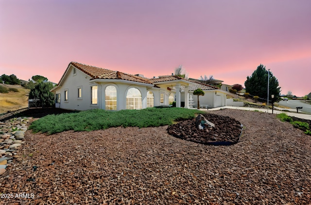4701 N Sheridan Ln, Prescott Valley, AZ 86314 - property exterior at dusk featuring a tiled roof and stucco siding