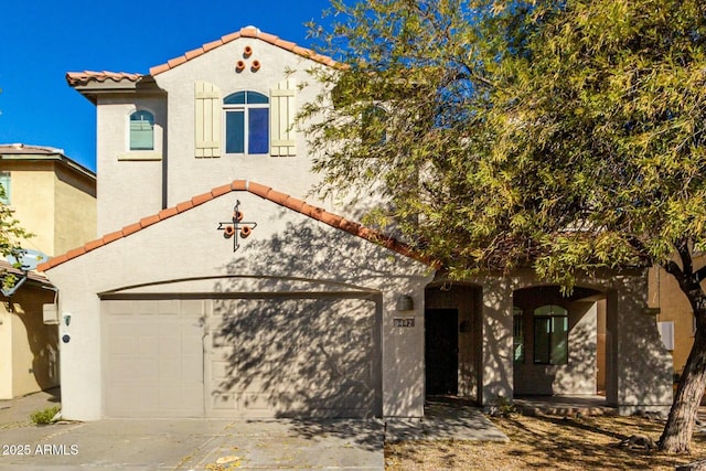 mediterranean / spanish house featuring a garage