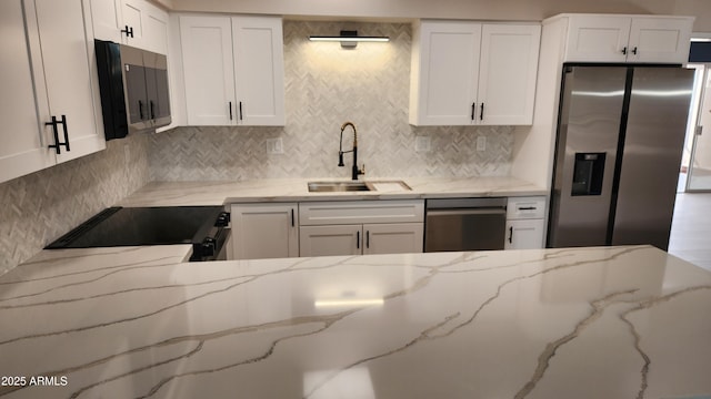 kitchen featuring sink, dishwasher, range, light stone countertops, and stainless steel fridge with ice dispenser