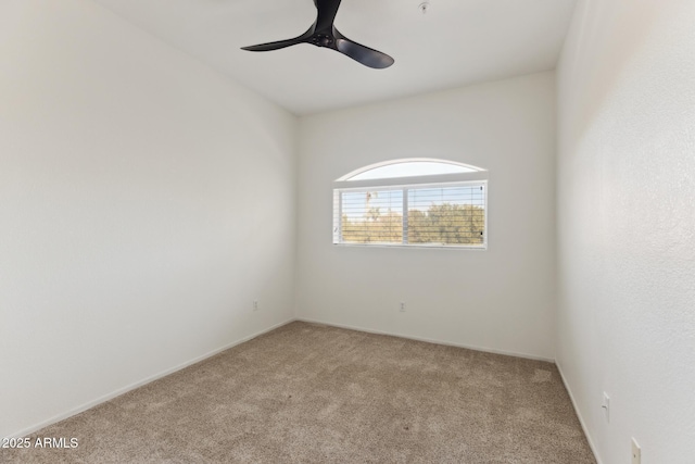 spare room with ceiling fan and light colored carpet