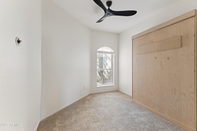 unfurnished bedroom featuring ceiling fan, a closet, and light carpet