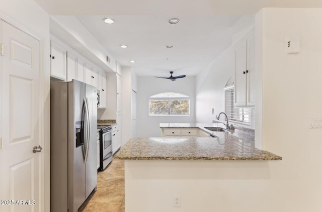 kitchen with white cabinetry, kitchen peninsula, ceiling fan, appliances with stainless steel finishes, and sink