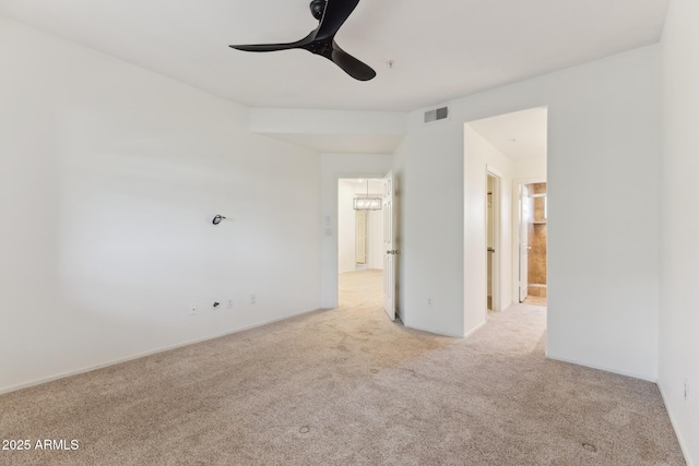 empty room featuring ceiling fan and light colored carpet