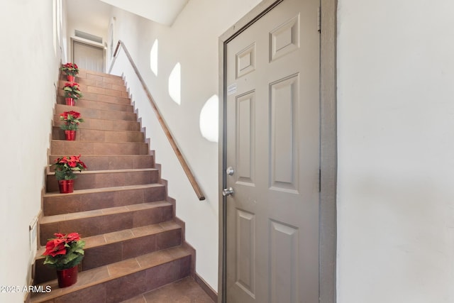 stairs with tile patterned floors