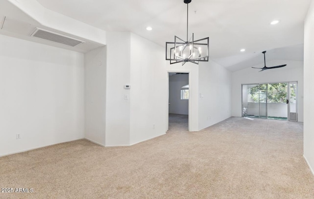 unfurnished room featuring ceiling fan with notable chandelier, light colored carpet, and lofted ceiling