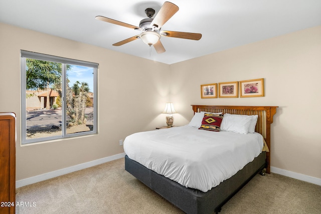 bedroom with light carpet and ceiling fan