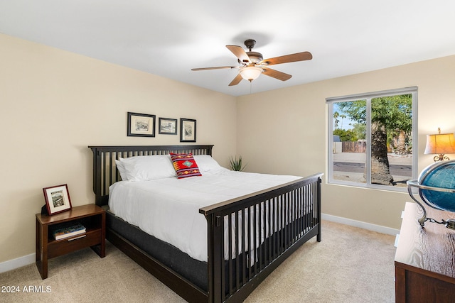 bedroom with ceiling fan and light carpet