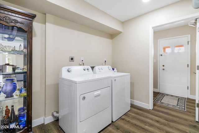 laundry area with washing machine and clothes dryer and dark hardwood / wood-style floors