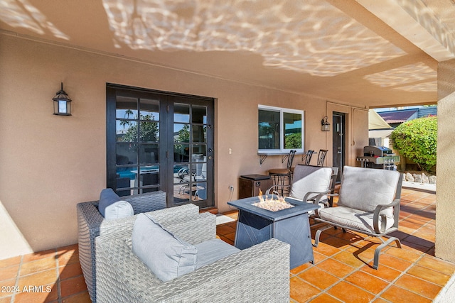 view of patio with french doors, area for grilling, and an outdoor fire pit