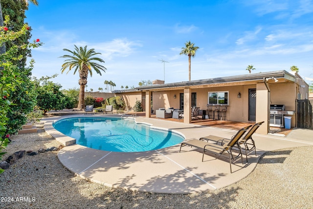 view of swimming pool featuring outdoor lounge area and a patio