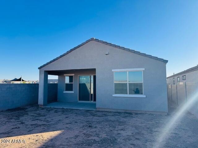 back of property with a patio area