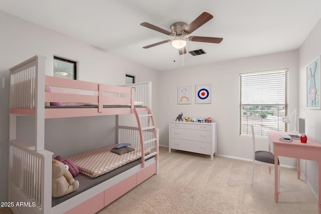 carpeted bedroom featuring a ceiling fan, visible vents, and baseboards