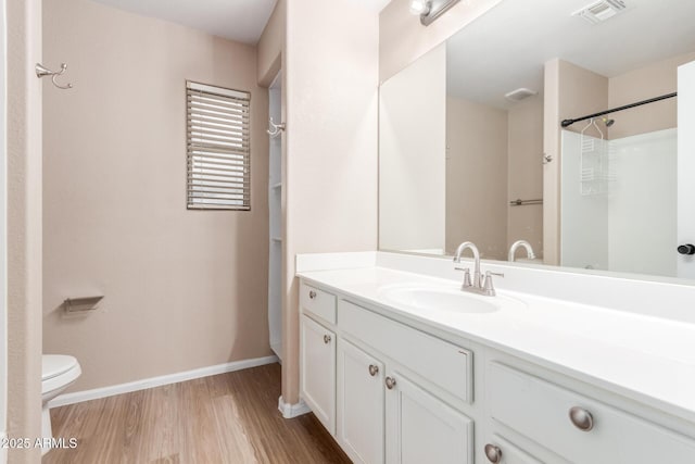 full bathroom featuring toilet, wood finished floors, vanity, visible vents, and baseboards