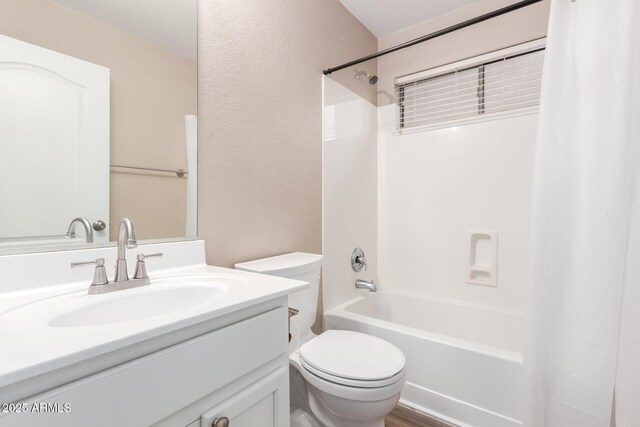 bathroom featuring toilet, shower / bath combo, and vanity