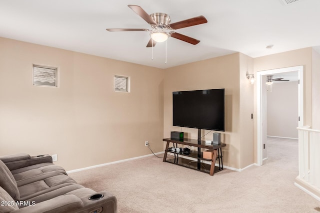 living area featuring a ceiling fan, carpet flooring, visible vents, and baseboards