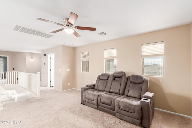 living area with visible vents, light carpet, and baseboards