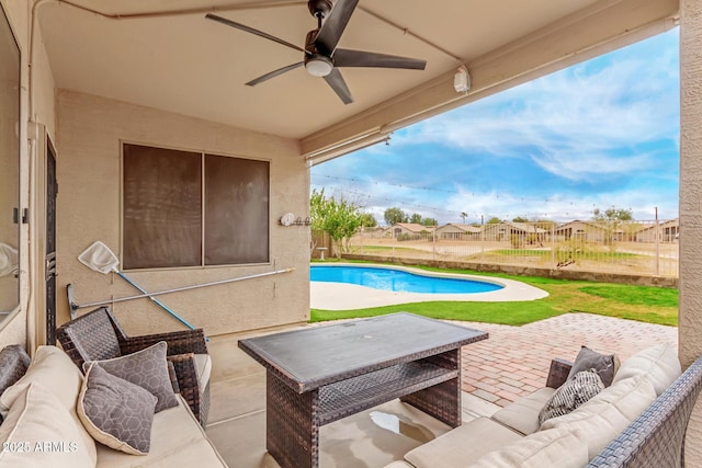 view of patio / terrace with a fenced in pool, an outdoor living space, and a ceiling fan