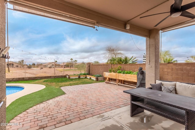 view of patio featuring ceiling fan, an outdoor hangout area, and a fenced backyard