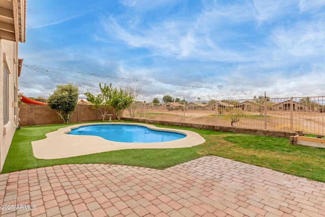 view of pool featuring a fenced backyard, a residential view, and a patio