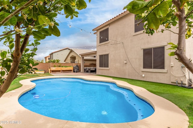 view of swimming pool featuring a patio area, fence, and a fenced in pool