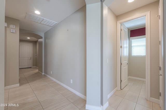 corridor featuring light tile patterned floors