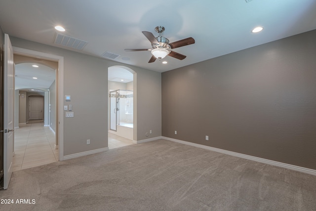 unfurnished room featuring light carpet and ceiling fan