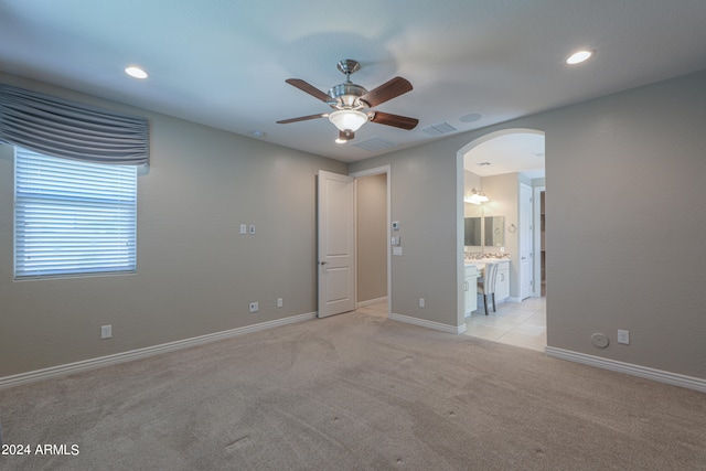 empty room featuring light carpet and ceiling fan