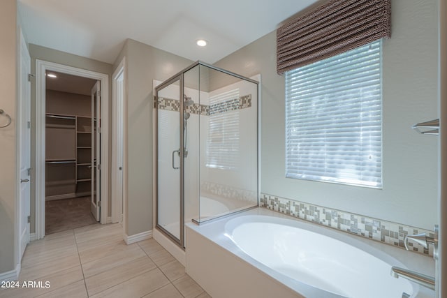 bathroom with separate shower and tub, tile patterned flooring, and a healthy amount of sunlight