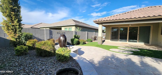 back of house featuring ceiling fan and a patio