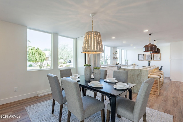 dining room with light wood-type flooring and sink