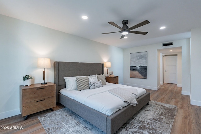 bedroom with ceiling fan and hardwood / wood-style floors