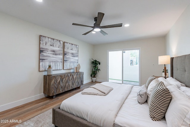 bedroom with wood-type flooring, access to outside, and ceiling fan