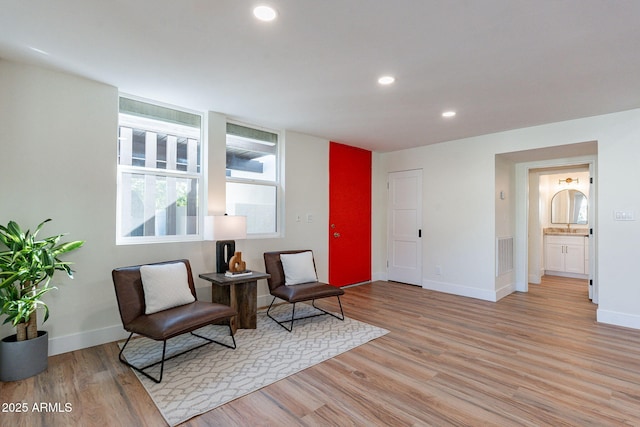 sitting room featuring light hardwood / wood-style floors