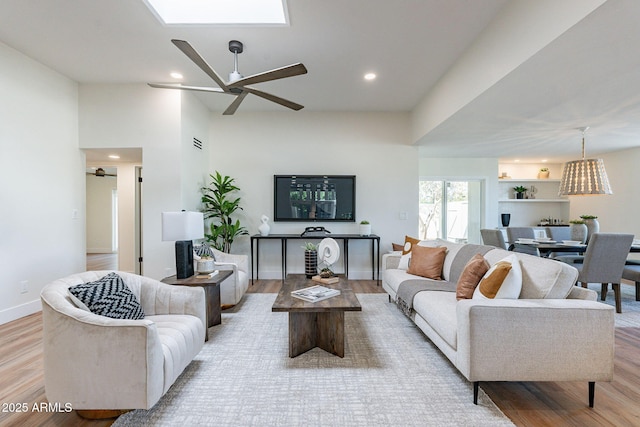 living room with light hardwood / wood-style floors and ceiling fan