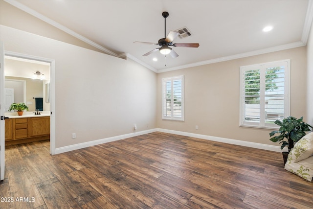 23705 N Chaps Dr, Florence, AZ 85132 - unfurnished bedroom with multiple windows, wood finished floors, vaulted ceiling, a sink, and crown molding